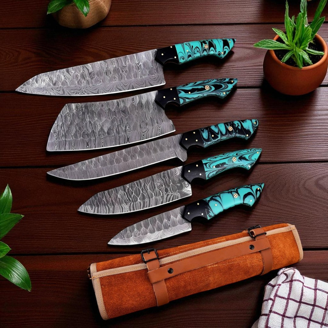 5-Piece Damascus Chef Knife Set with turquoise and black swirled handles, displayed on a wooden surface next to raw meat and garlic.