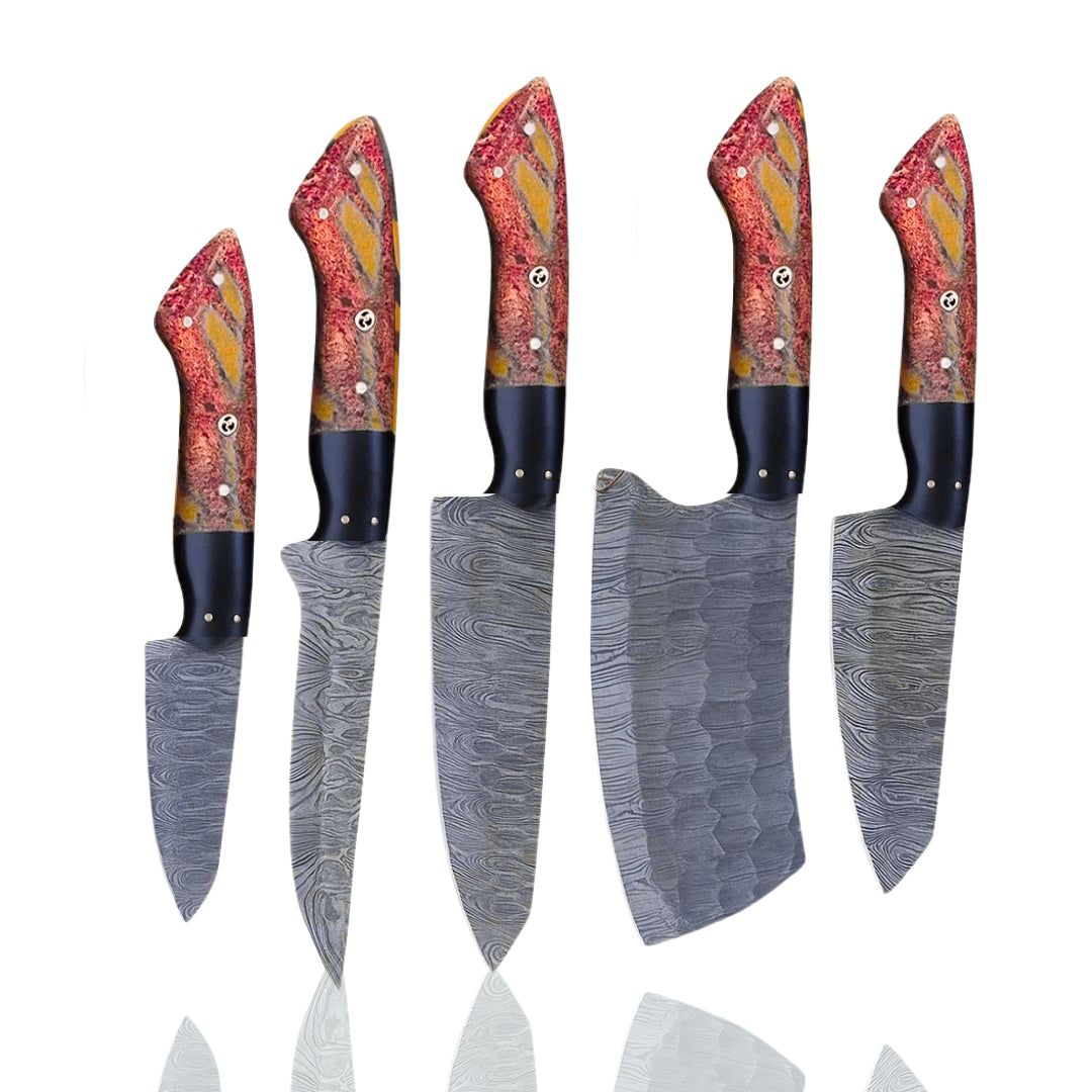 Five handmade Damascus steel chef knives with vibrant red, orange, and yellow patterned resin handles, displayed upright on a white background