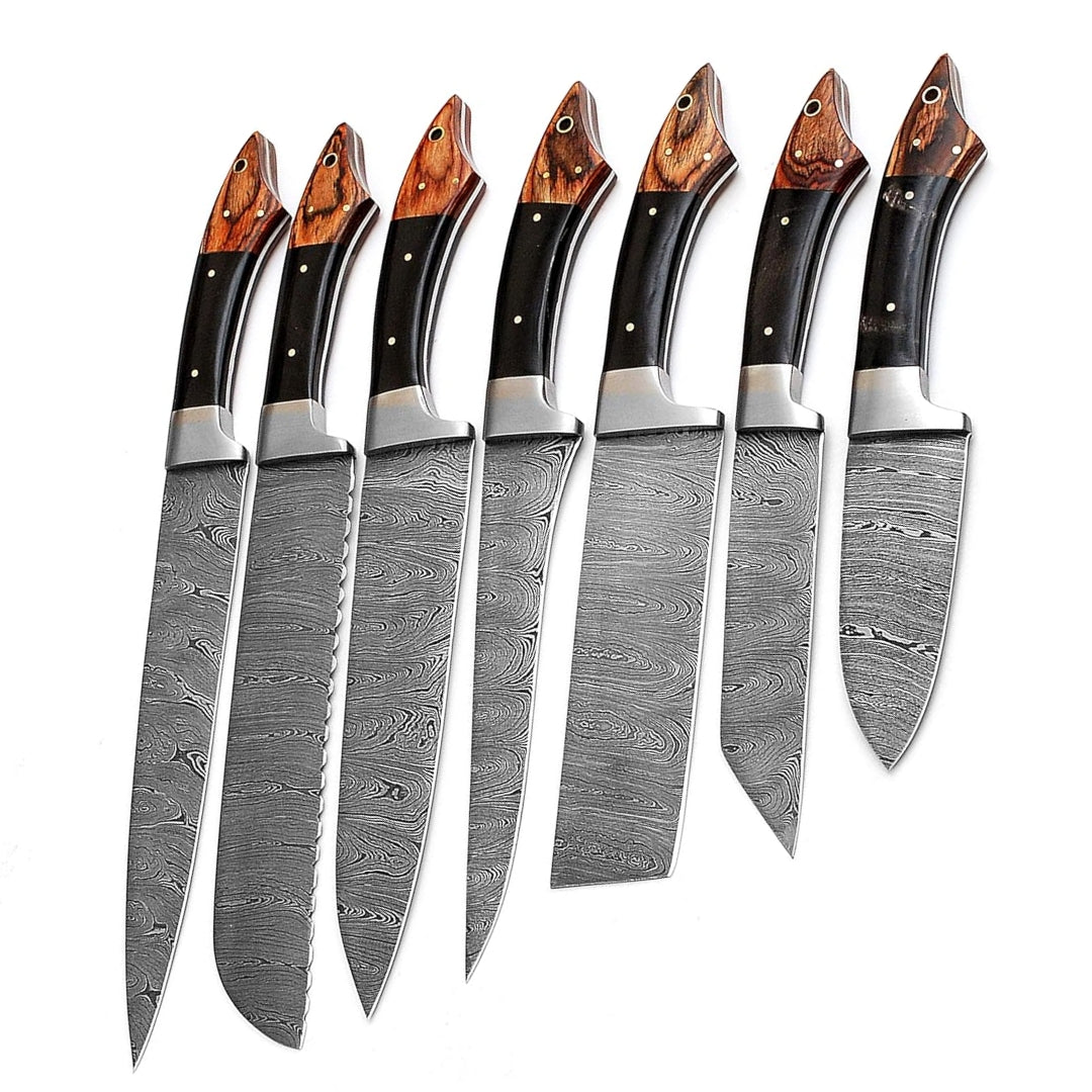 Close-up view of the two-tone wood handles with metal bolsters and rivets on a set of Damascus steel kitchen knives, highlighting the material and design