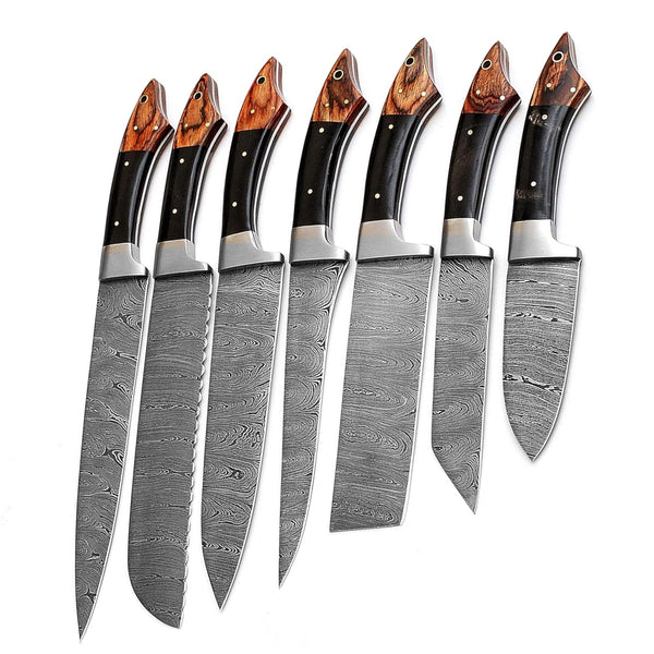 Close-up view of the two-tone wood handles with metal bolsters and rivets on a set of Damascus steel kitchen knives, highlighting the material and design