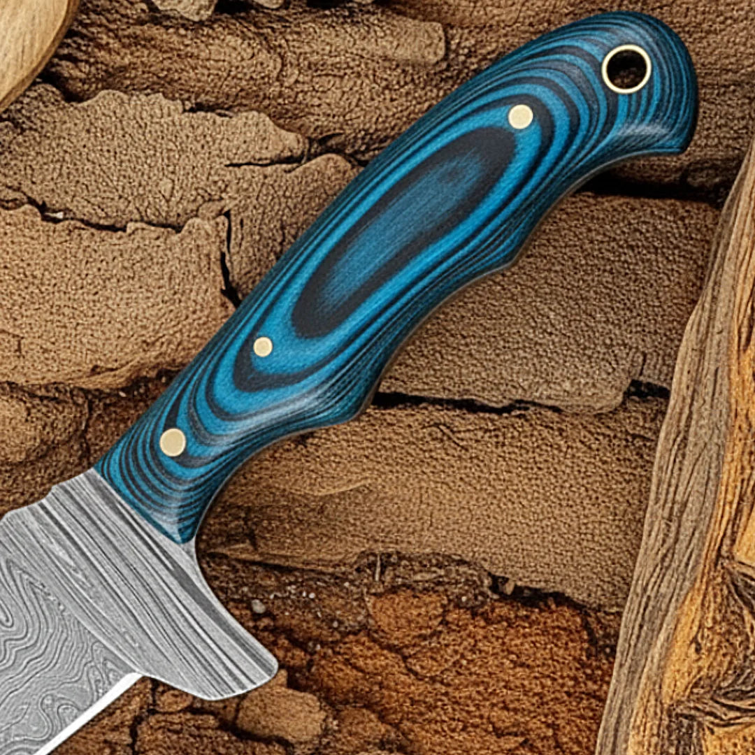 Cowboy bull Cutter Knife with a blue pakkawood handle on a wooden background