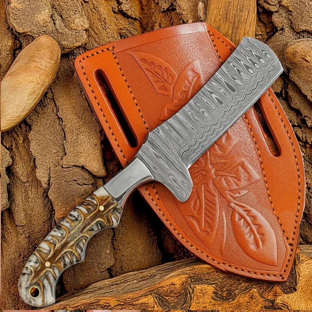 Damascus Bull Cutter knife with a detailed blade and brown leather sheath on a textured stone background