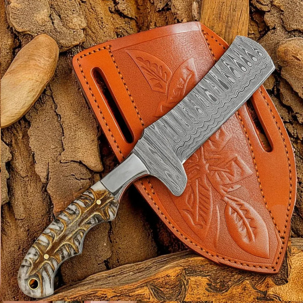 Damascus Bull Cutter knife with a detailed blade and brown leather sheath on a textured stone background