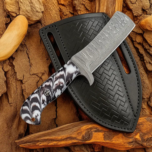 A close-up shot of an 8-inch handmade Damascus calf cutter knife resting on a dark leather sheath, showcasing its intricate blade pattern and black-and-white resin handle design.