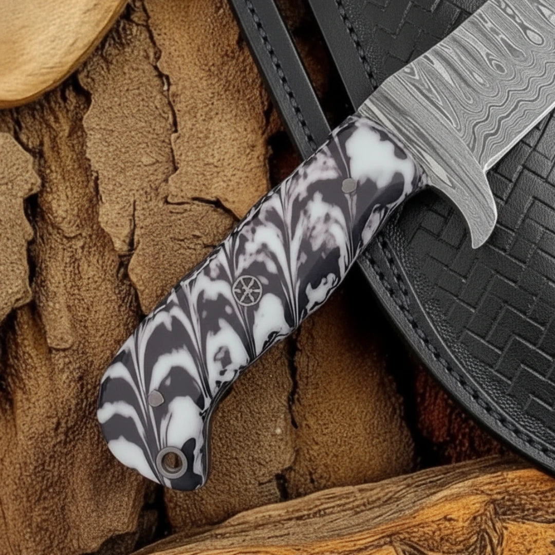 A detailed view of the black-and-white resin handle of the 8-inch Damascus calf cutter knife, highlighting the texture and design of the handle.
