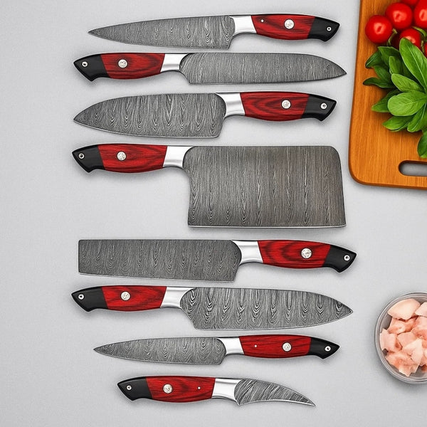Set of knives with red and black handles on a gray background