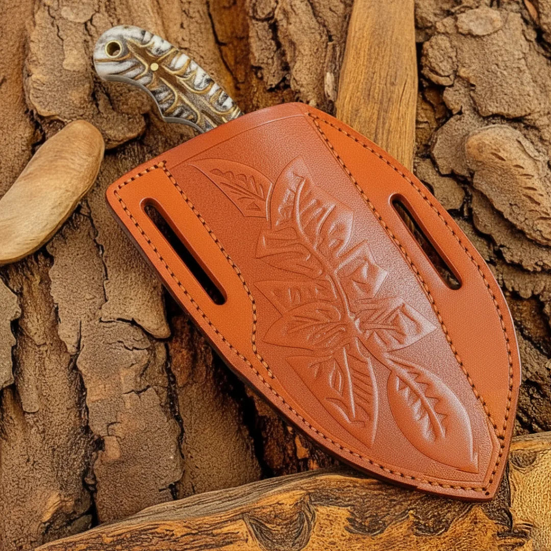 Brown leather knife sheath with leaf patterns on a wooden background