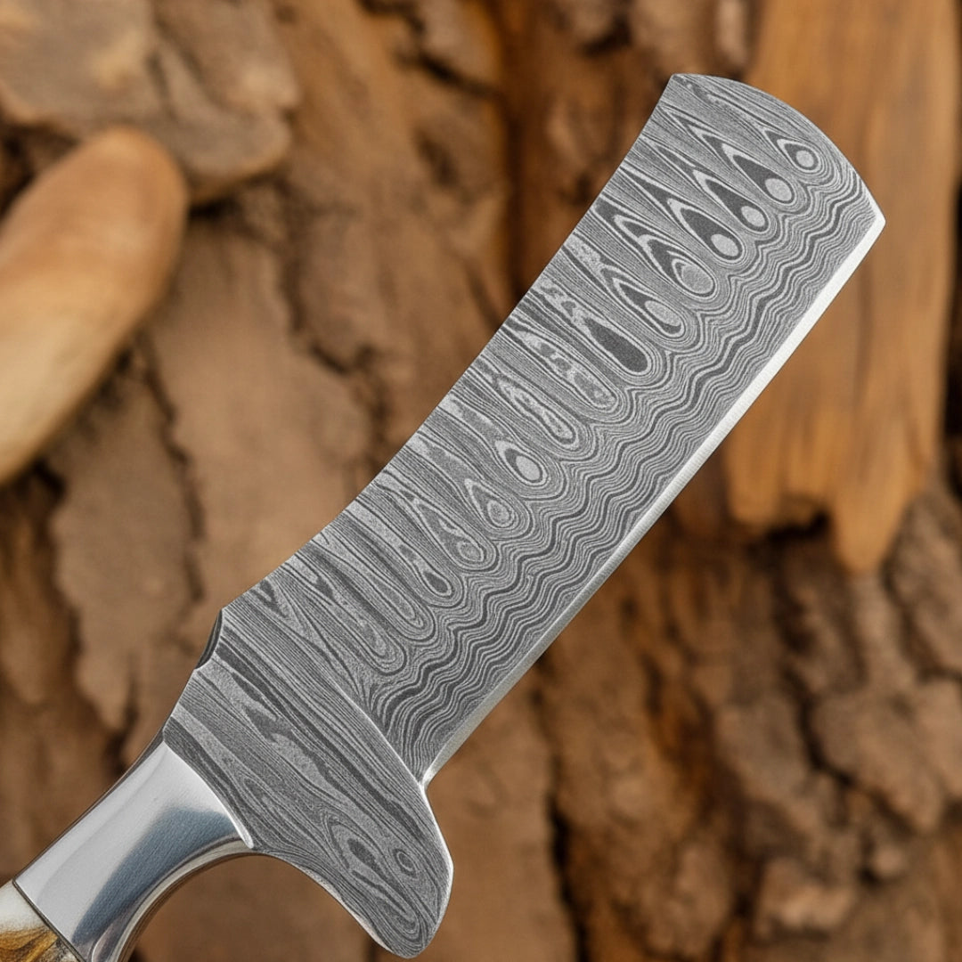 Damascus Bull Cutter knife blade against a wooden background