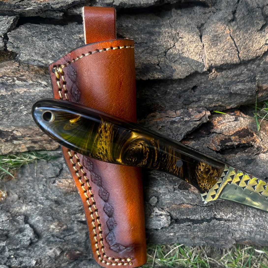 Cowboy Bull cutter Knife with a brown leather sheath on a stone surface