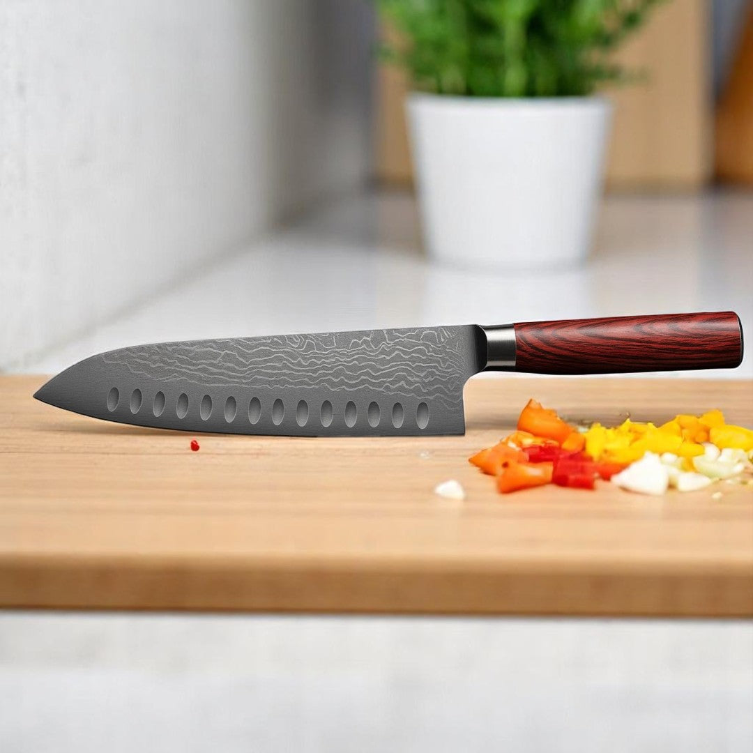 7 inch Damascus Santoku knife with wooden handle on a cutting board next to chopped red and yellow peppers