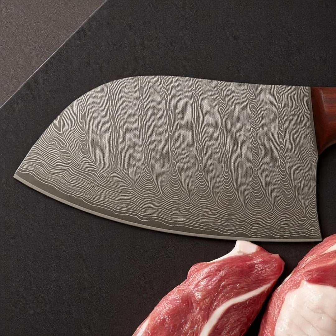 Close-up view of the wavy pattern Damascus steel blade of a Classic Damascus Serbian Chef Knife, showing its unique texture near raw meat cuts