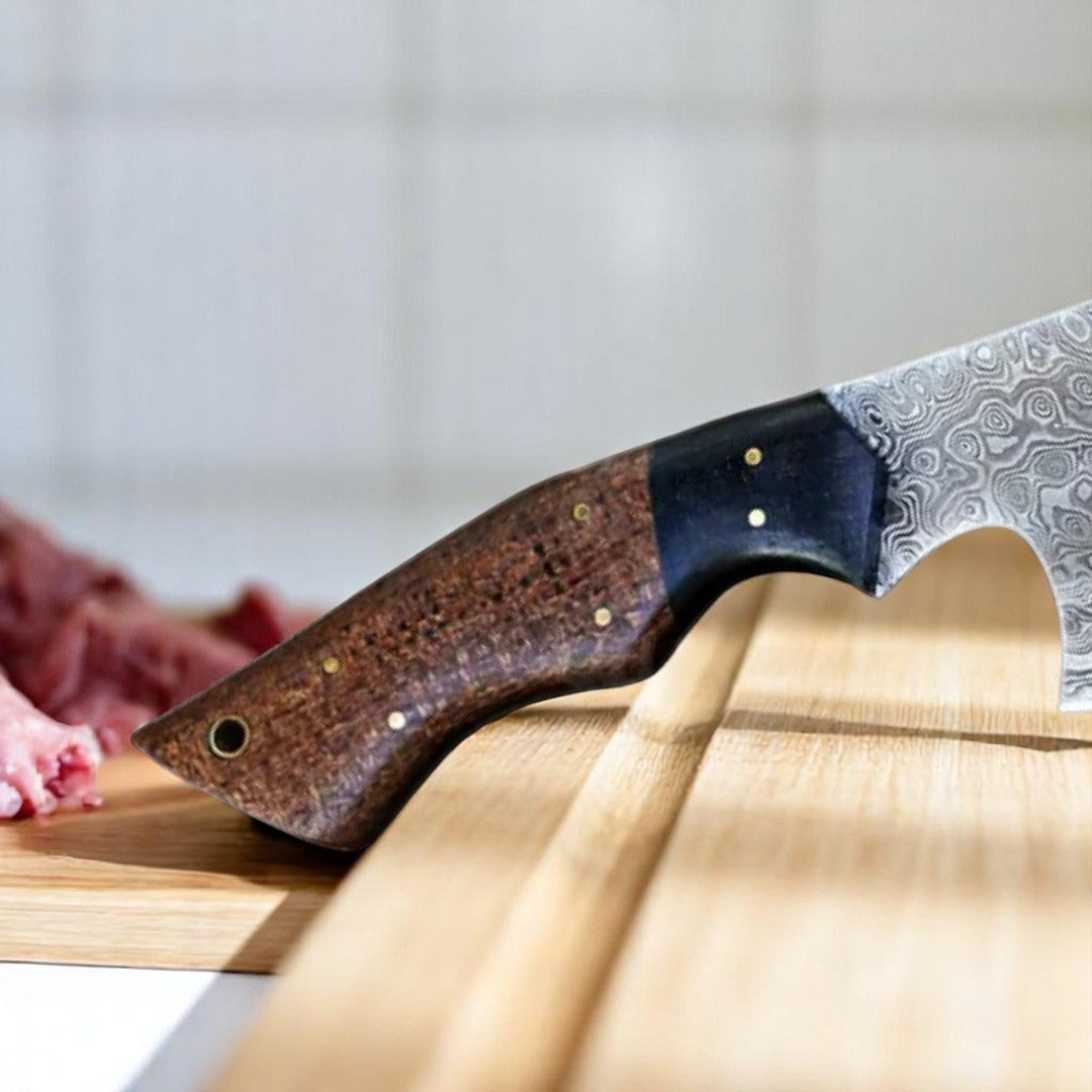 Hand holding a Damascus Butcher Cleaver Knife with a unique Micarta handle and patterned blade over raw meat cuts.