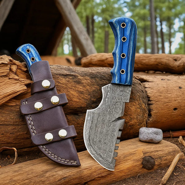 Tracker Knife with blue handle and leather sheath on wooden logs with a forest background
