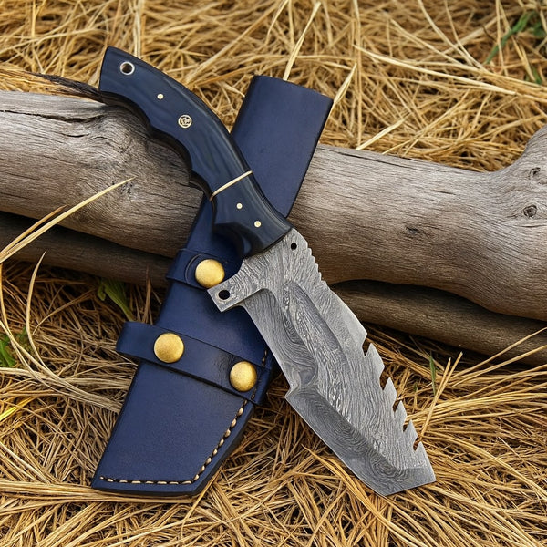 Tracker Knife with blue sheath on a wooden log and straw background