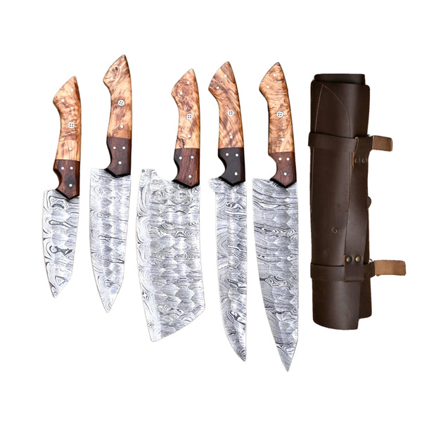 Five custom hand-forged Damascus steel chef knives with unique wood handles and twist patterns, displayed upright next to a brown leather knife roll on a white background