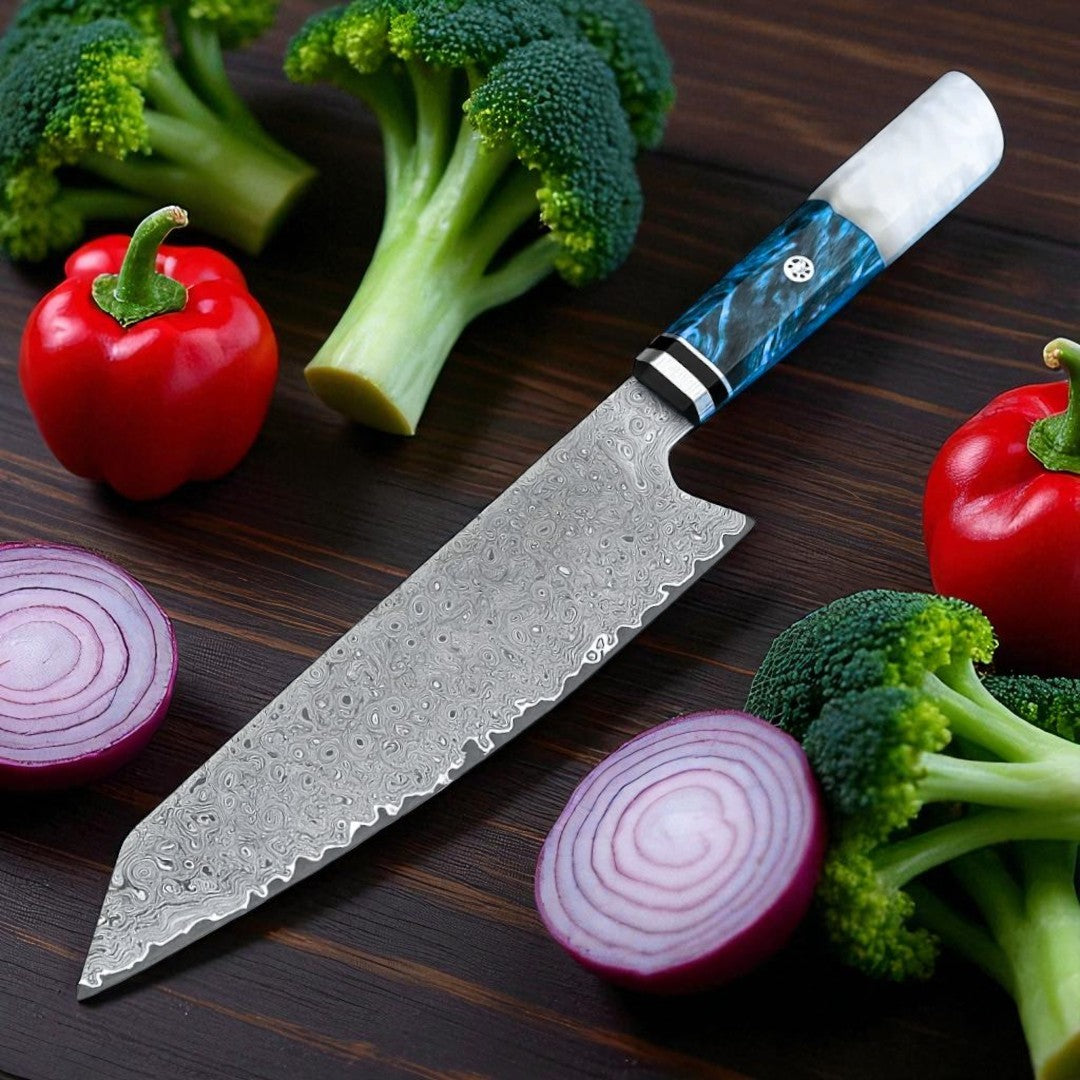 Chef's knife with a decorative handle on a wooden surface surrounded by vegetables.