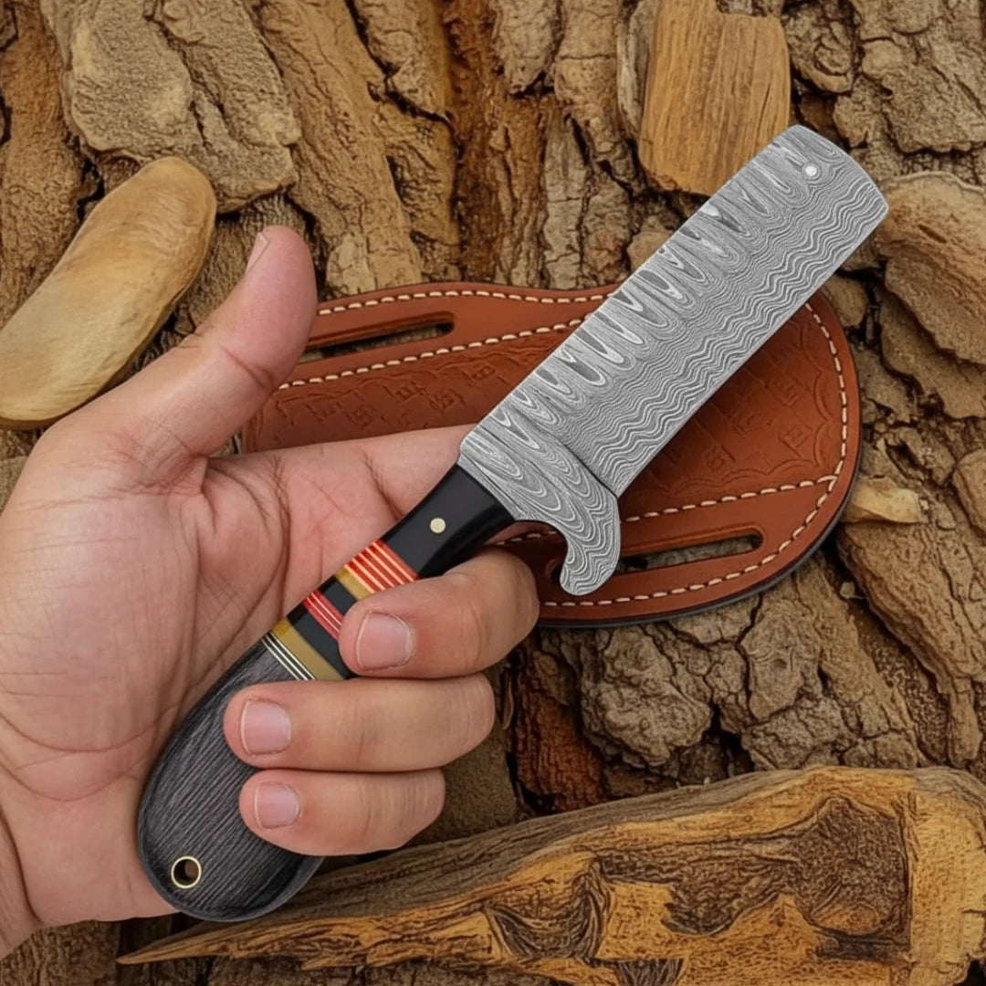 Hand holding a Bull Cutter knife with a detailed blade against a wooden background