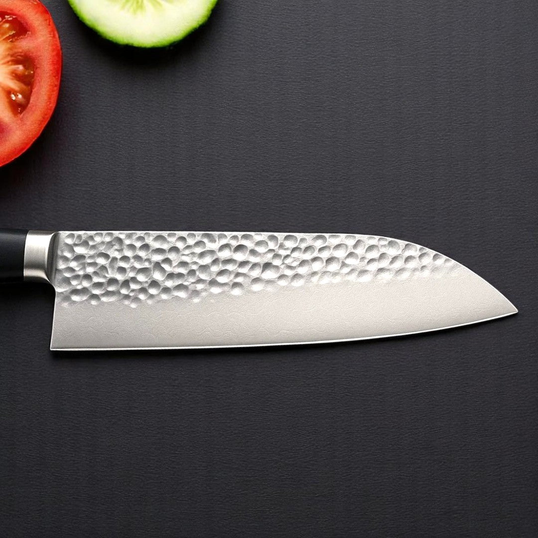 Hammered finish Santoku knife blade showing textured surface with vegetables

