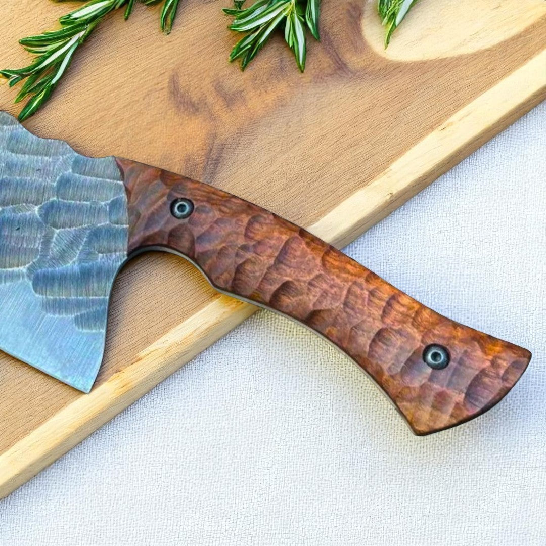  Close-up view of the textured walnut wood handle of the Bone Splitter Serbian Cleaver Knife, showing its ergonomic shape and rivets.