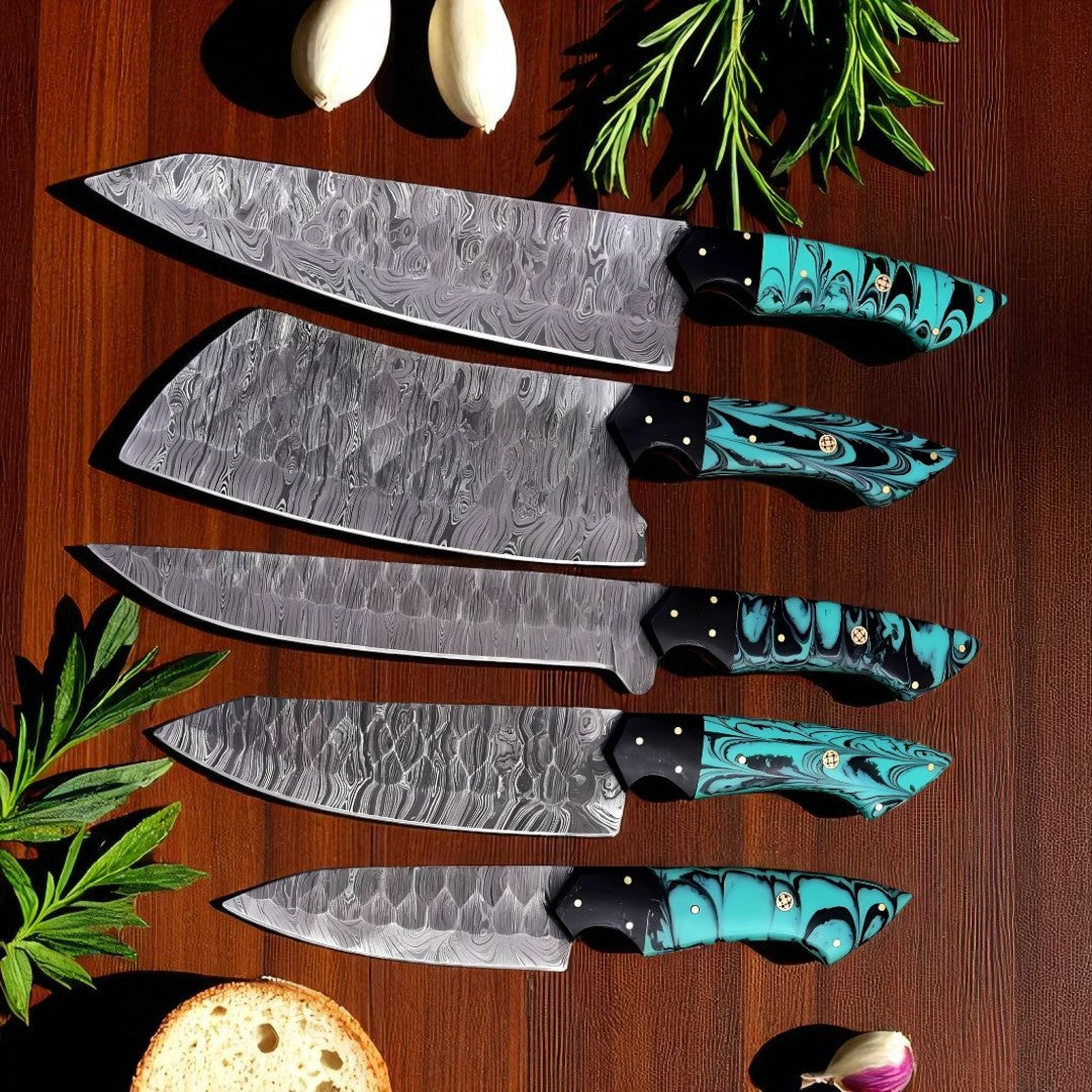 5-Piece Damascus Chef Knife Set with turquoise and black swirled handles and wavy Damascus blades, arranged on a wooden table with fresh herbs.