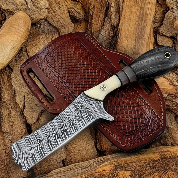 Full view of Damascus Cowboy Bull Cutter Knife featuring patterned steel blade and bone-handle leather sheath..
