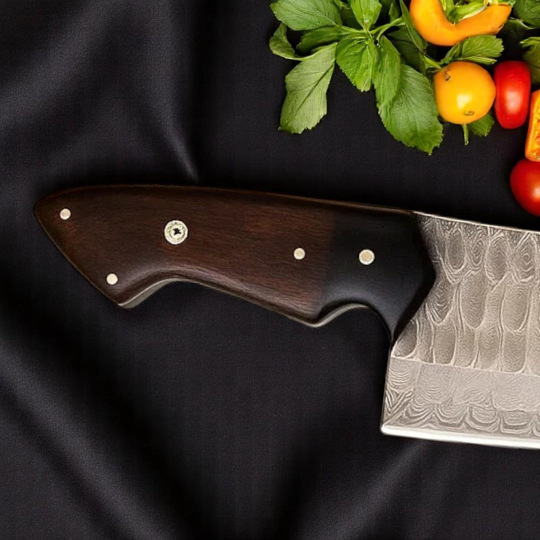 Close-up view of the Rosewood and G10 Black Micarta handle of a Damascus Chef Knife, showing texture and rivets
