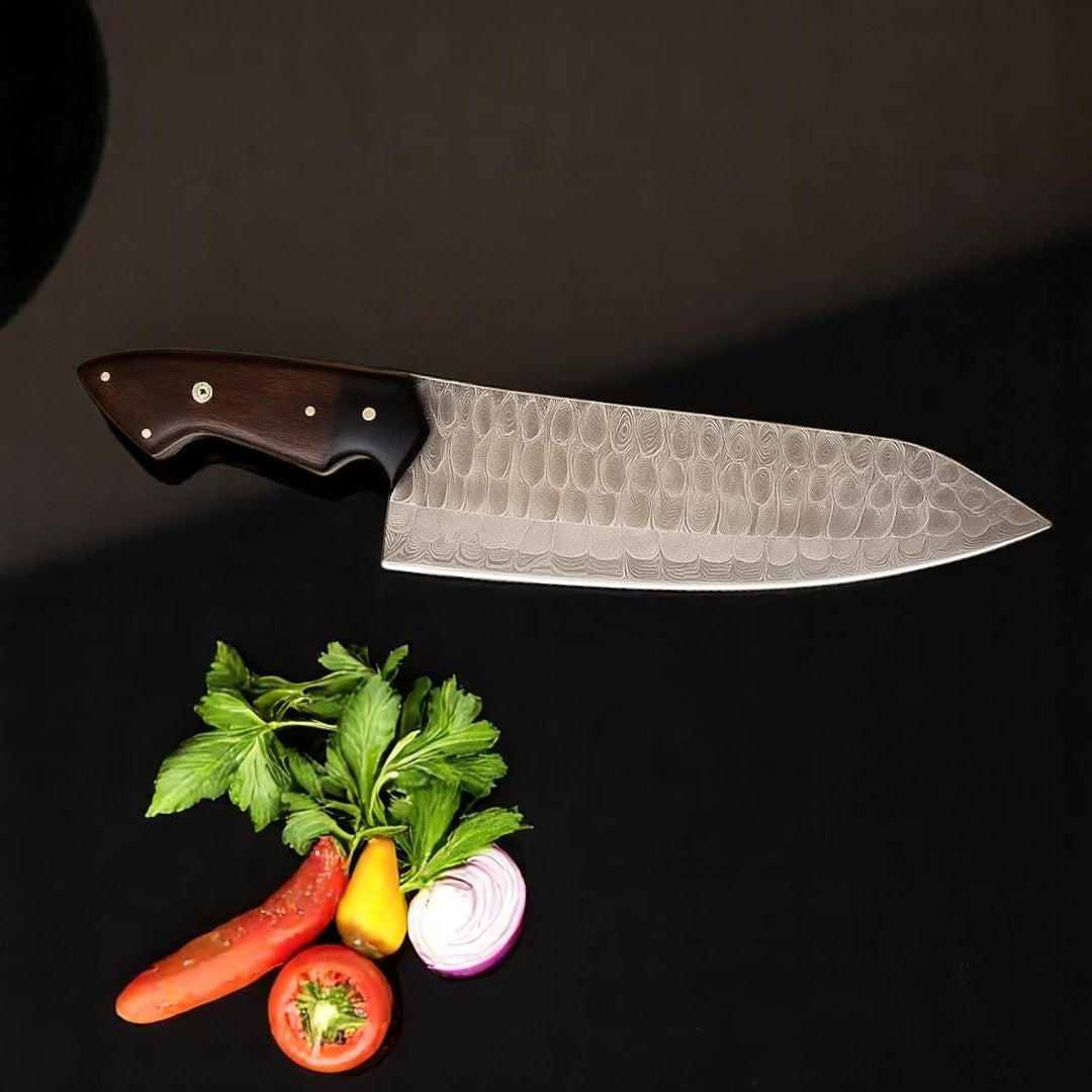 Damascus Chef Knife with Rosewood and G10 handle, showing blade pattern, on a black surface with fresh vegetables