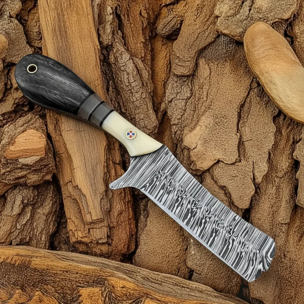 Full view of Cowboy Bull Cutter Knife featuring patterned steel blade and bone-ebony handle.