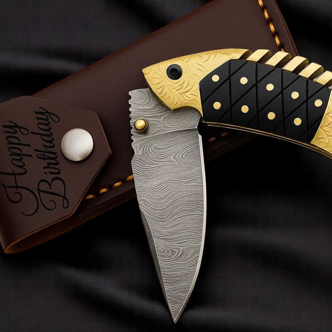 Close-up view of the brown leather sheath for a Damascus Fish-Shaped Folding Knife, showing the "Happy Birthday" engraving and snap closure.
