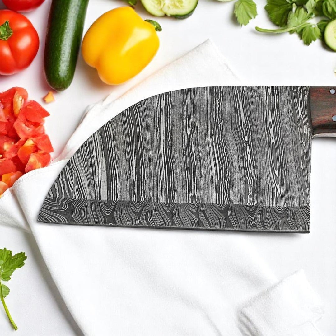 Handmade Damascus Serbian Almazan Cleaver knife blade with unique wavy pattern, shown close-up on a black surface next to raw meat cuts

