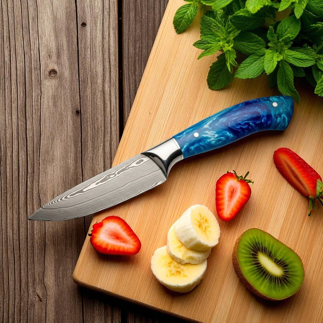 paring Knife with blue handle on a wooden cutting board with sliced fruits and herbs