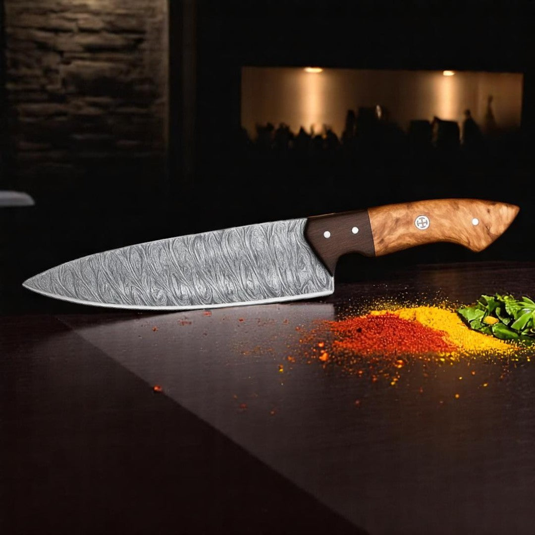 Japanese Damascus Chef Knife with wavy brocade blade pattern resting on a dark surface with red and yellow spices, showing handle detail

