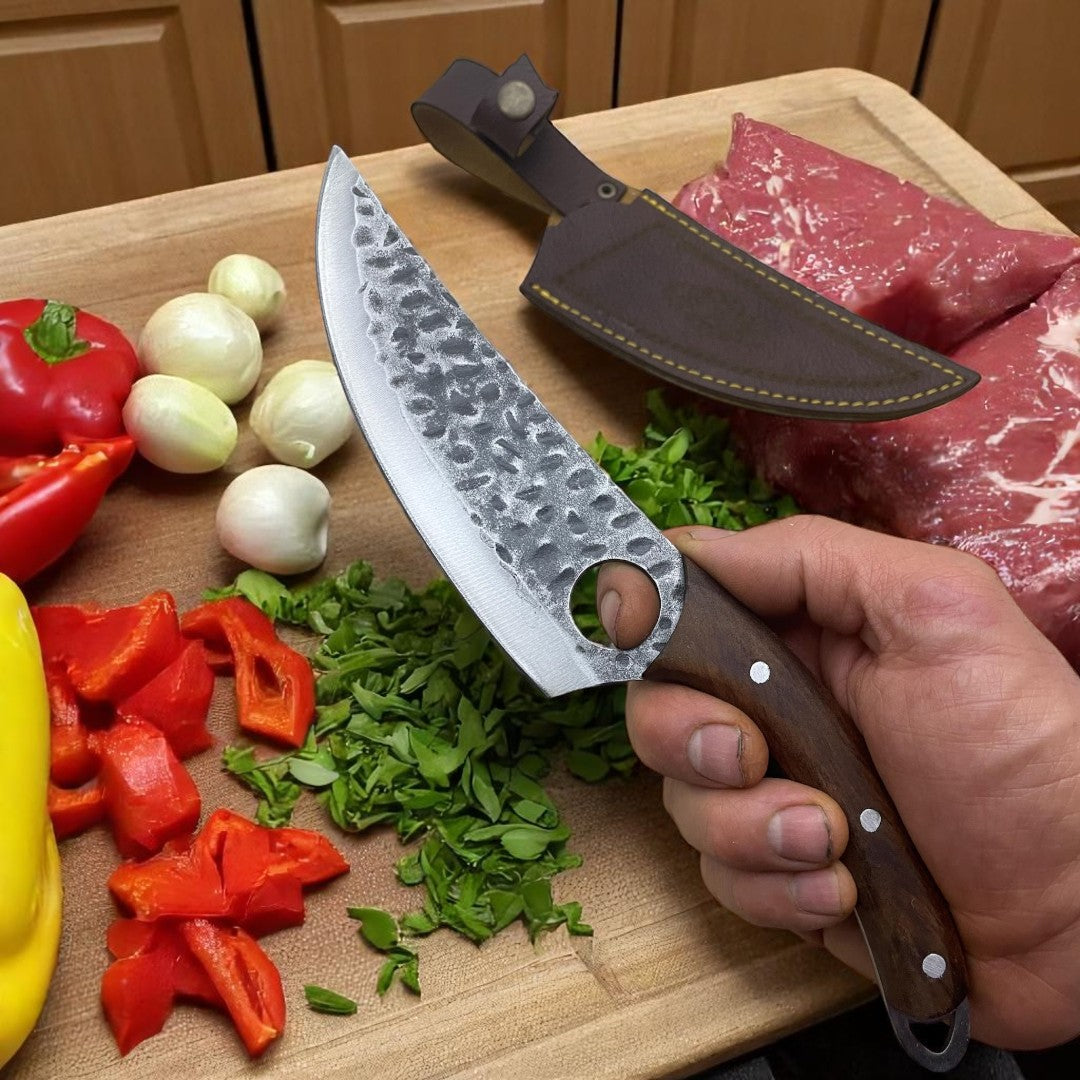 Hand holding a Viking Hand-Foraged Boning Knife with finger hole in a grip position, over chopped vegetables on a wooden cutting board.