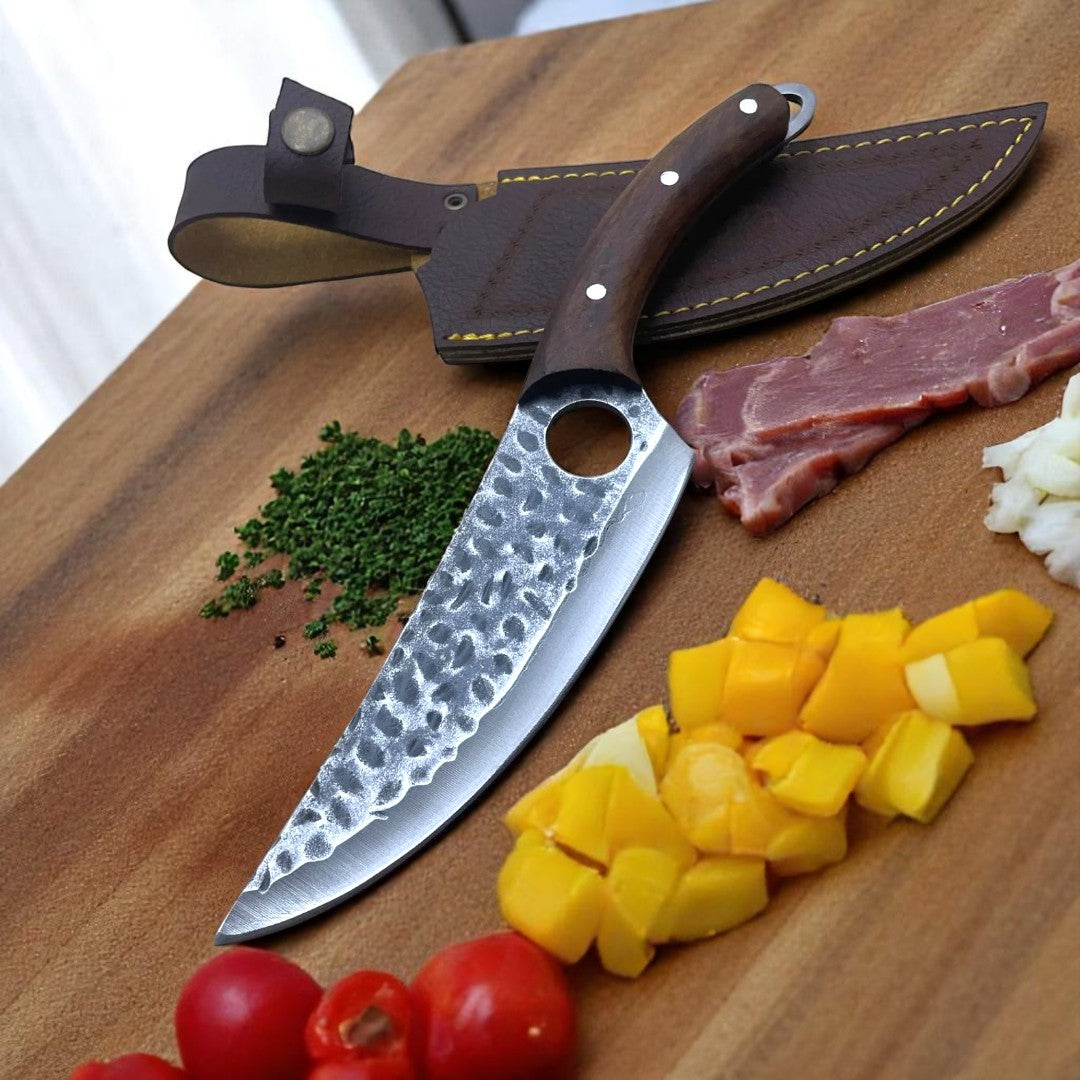 Viking Hand-Foraged Boning Knife with textured wood handle and finger hole, secured in its brown leather sheath on a wooden cutting board.